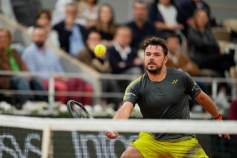 Wawrinka plays a shot against Murray
